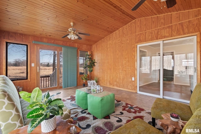 unfurnished sunroom featuring ceiling fan, lofted ceiling, a healthy amount of sunlight, and wooden ceiling