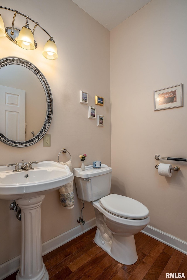 bathroom with sink, hardwood / wood-style flooring, and toilet