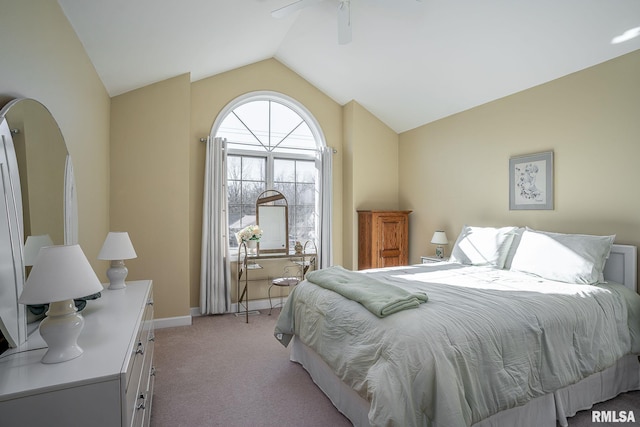 bedroom featuring light carpet, lofted ceiling, and ceiling fan