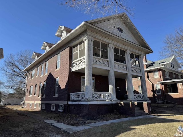 view of side of property featuring covered porch