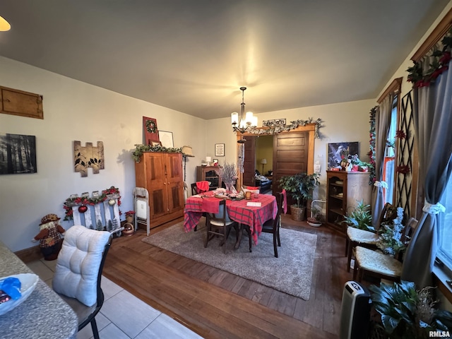 dining area featuring an inviting chandelier and light hardwood / wood-style floors