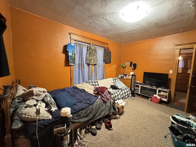 bedroom with a textured ceiling and carpet