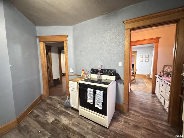 kitchen featuring electric range oven, white cabinets, and dark hardwood / wood-style flooring