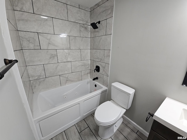 full bathroom with vanity, tiled shower / bath combo, and toilet