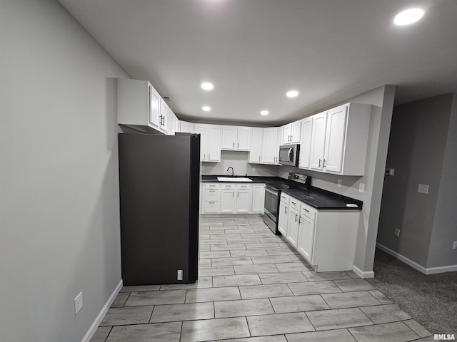 kitchen with white cabinetry, stainless steel appliances, and sink