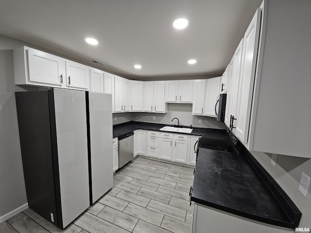 kitchen with white cabinetry, appliances with stainless steel finishes, and sink