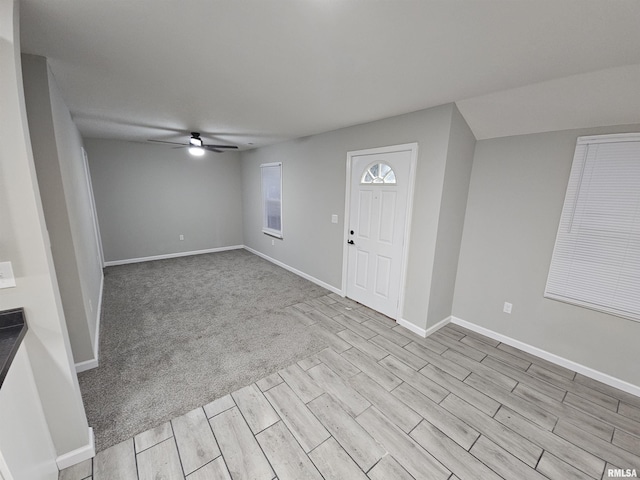 foyer with ceiling fan and light wood-type flooring