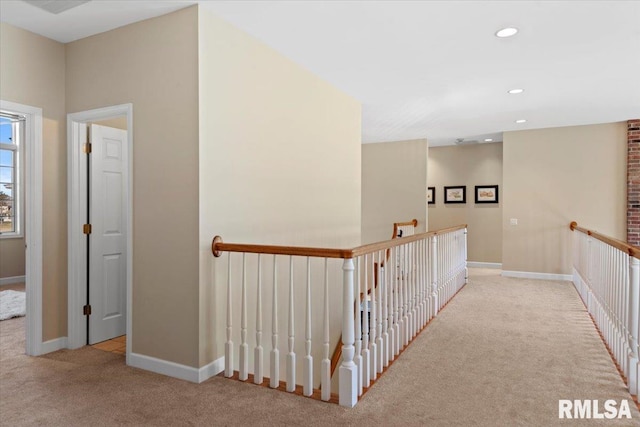 hallway featuring light colored carpet