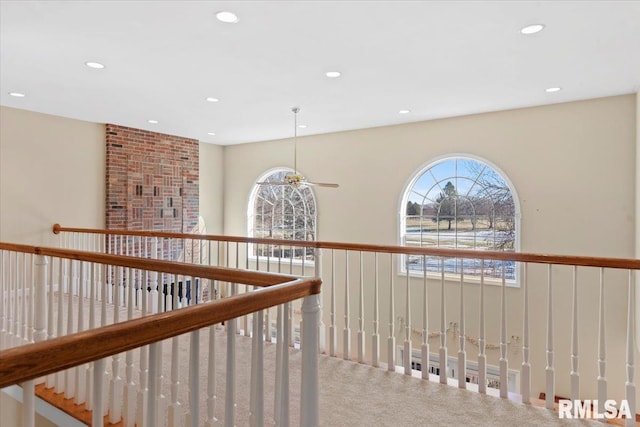 hall featuring carpet and a wealth of natural light