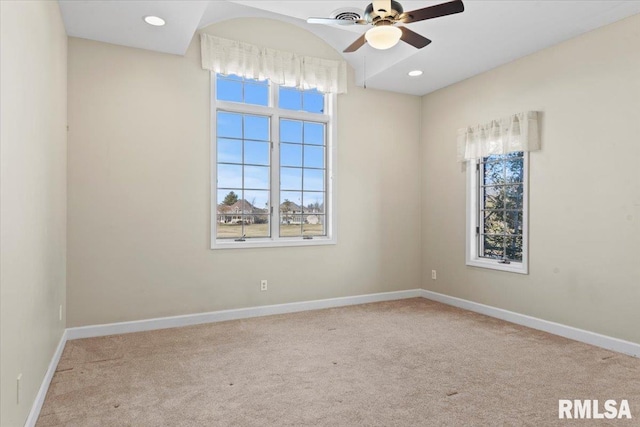 spare room featuring ceiling fan and light colored carpet