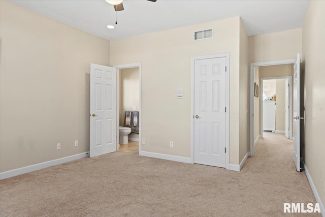 unfurnished bedroom with washer / dryer and light carpet