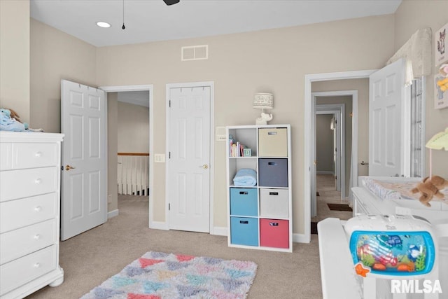 bedroom featuring light carpet