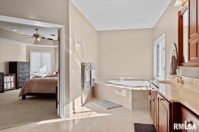 bathroom with ceiling fan, vanity, tiled bath, and tile patterned flooring