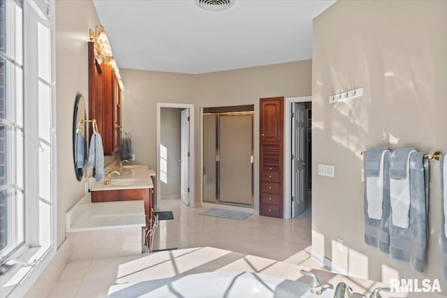 bathroom featuring tile patterned floors, independent shower and bath, and vanity