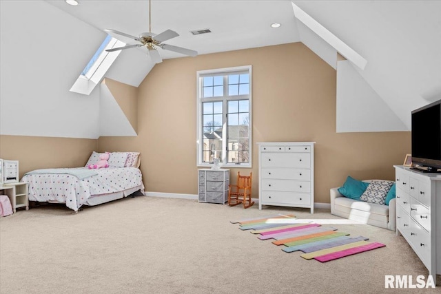 carpeted bedroom with lofted ceiling with skylight and ceiling fan