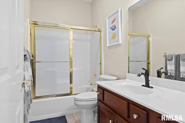 full bathroom with toilet, vanity, bath / shower combo with glass door, and tile patterned flooring