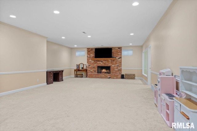 rec room featuring ornamental molding, a brick fireplace, and light carpet