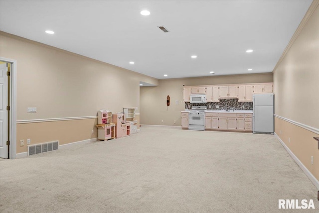 playroom with ornamental molding, sink, and light colored carpet