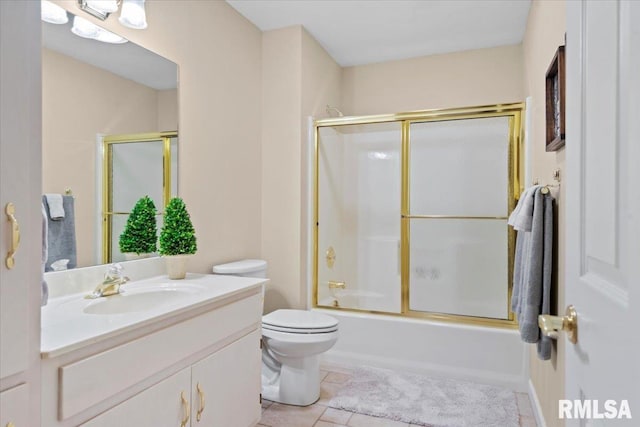 full bathroom featuring tile patterned flooring, vanity, enclosed tub / shower combo, and toilet