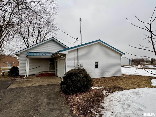 view of snowy exterior with a garage