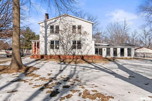 snow covered house featuring covered porch