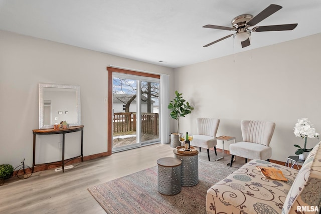 living room with light hardwood / wood-style flooring and ceiling fan