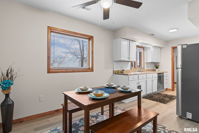 34187 E 6th Rd, Pawnee, IL 62558 - dining room featuring visible vents, baseboards, ceiling fan, and a healthy amount of sunlight