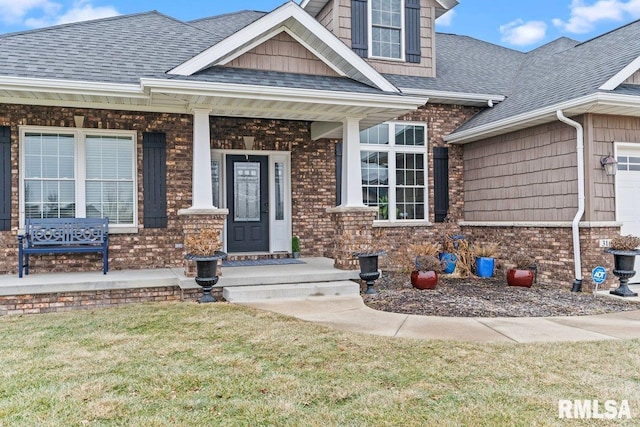 property entrance featuring covered porch and a lawn