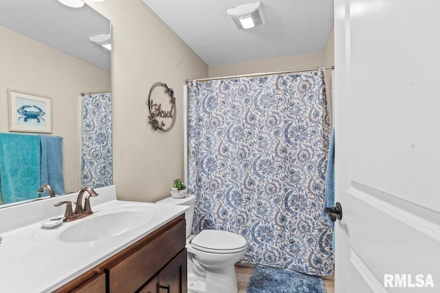 bathroom featuring vanity, tile patterned floors, and toilet