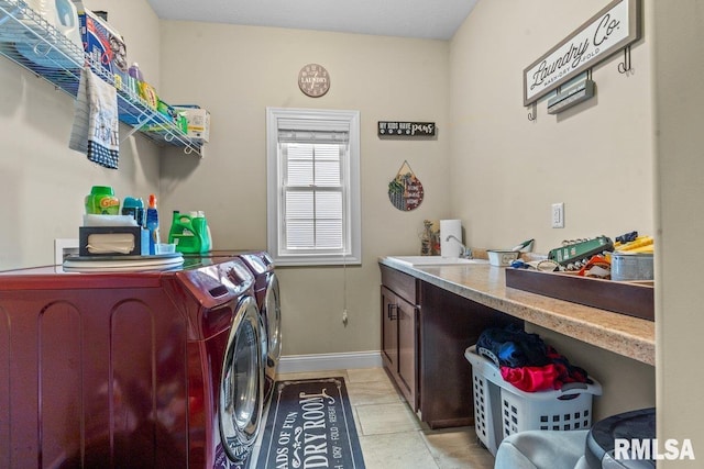 laundry room with light tile patterned flooring, sink, and washing machine and clothes dryer