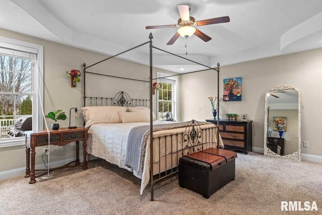 bedroom with multiple windows, ceiling fan, and carpet