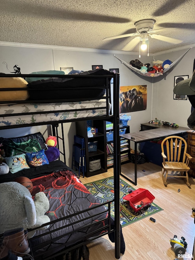 bedroom featuring crown molding, ceiling fan, hardwood / wood-style flooring, and a textured ceiling