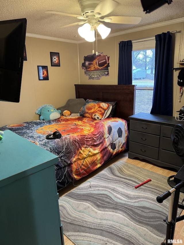 bedroom with crown molding, wood-type flooring, and a textured ceiling