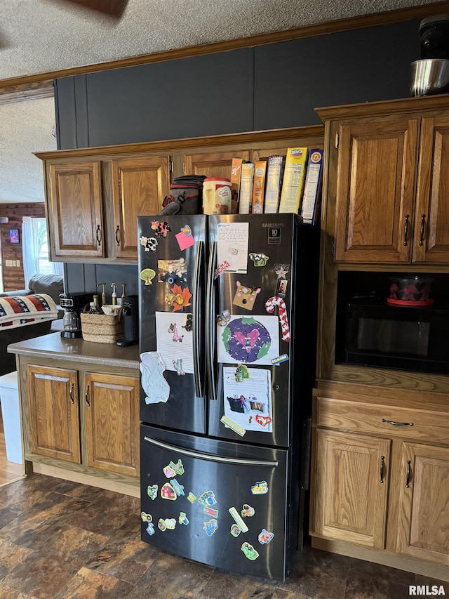 kitchen featuring a textured ceiling and refrigerator