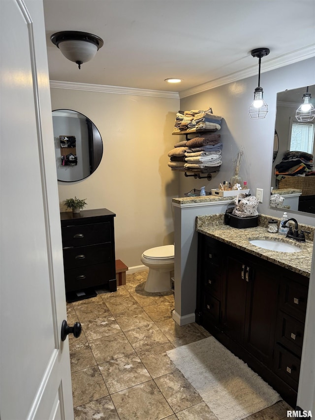 bathroom featuring crown molding, vanity, and toilet