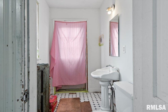810 E Edwards St, Springfield, IL 62703 - half bath with tile patterned floors, toilet, and healthy amount of natural light