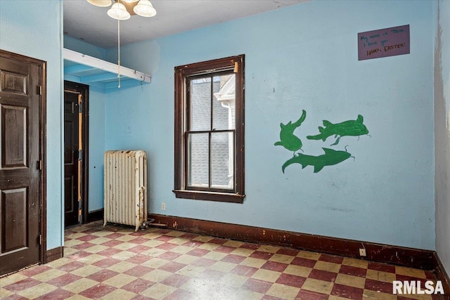 810 E Edwards St, Springfield, IL 62703 - unfurnished room featuring radiator heating unit, light floors, and baseboards