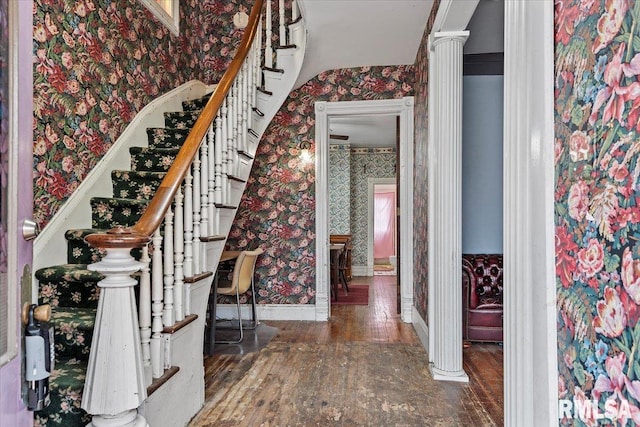 810 E Edwards St, Springfield, IL 62703 - entrance foyer featuring wallpapered walls, wood-type flooring, stairs, baseboards, and decorative columns