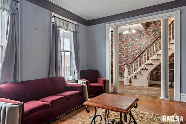 810 E Edwards St, Springfield, IL 62703 - living area featuring wood finished floors, a chandelier, stairway, ornate columns, and wallpapered walls