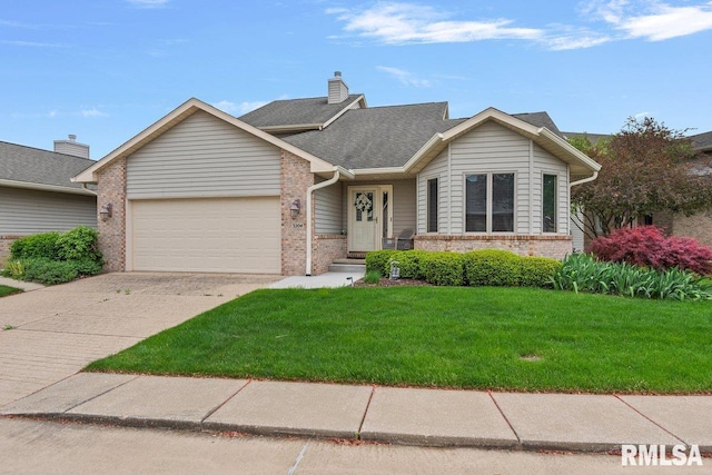 view of front of home featuring roof with shingles, an attached garage, brick siding, a front yard, and a chimney