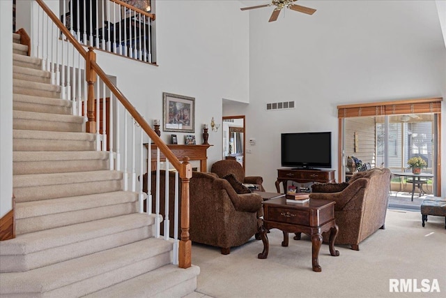 carpeted living room with ceiling fan