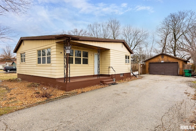 view of front of property featuring a garage and an outbuilding