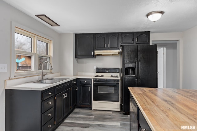 kitchen with sink, dark wood-type flooring, wine cooler, black refrigerator with ice dispenser, and white gas stove