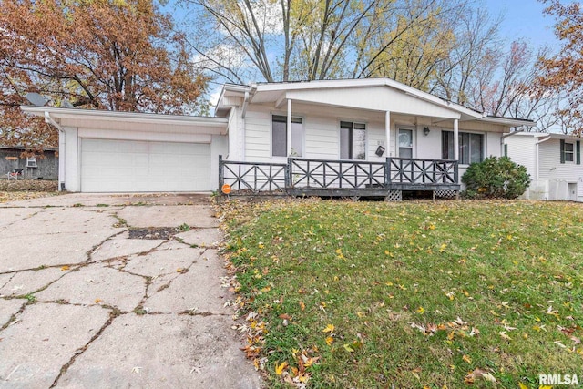 ranch-style home featuring a garage, a front lawn, and a porch