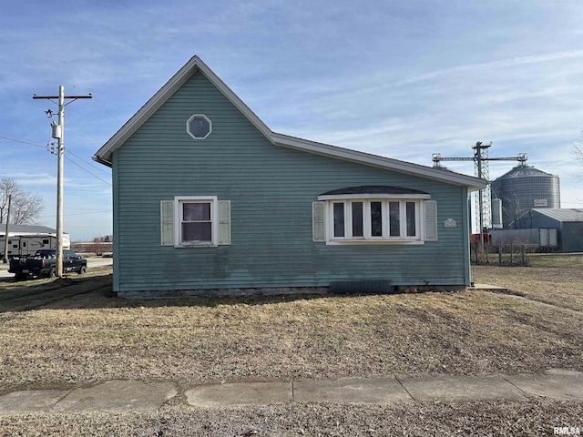 view of property exterior featuring a lawn