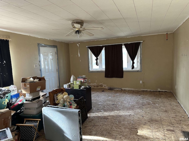 interior space with crown molding and ceiling fan