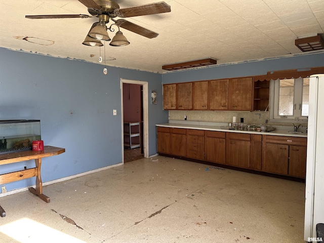 kitchen featuring sink, a textured ceiling, and ceiling fan