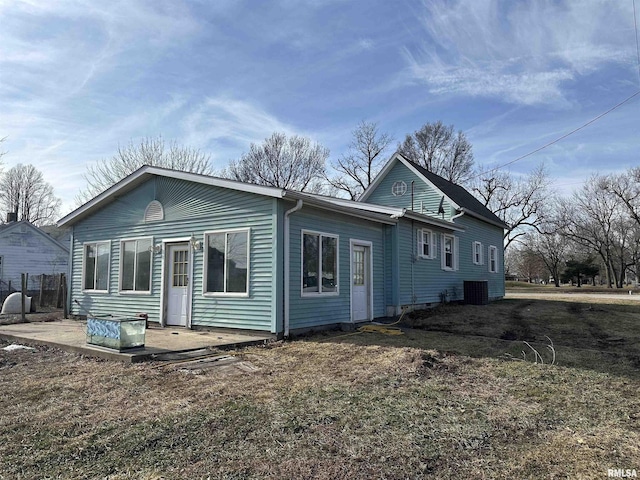 back of house featuring a yard and a patio area