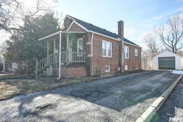 view of home's exterior with a garage, an outbuilding, and covered porch