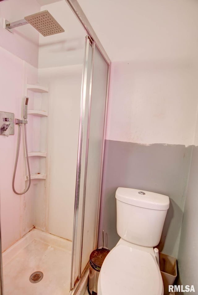 bathroom with toilet and a shower